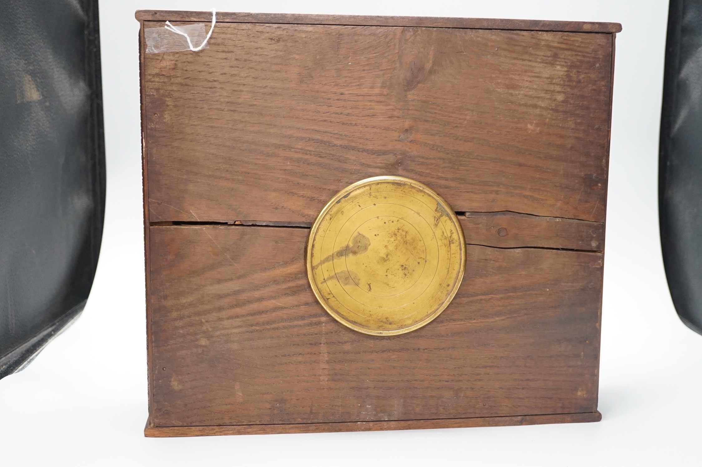 A late 19th century / early 20th century folk art carved oak cased clock, decorated with hanging dead game amongst oak sprigs and acorns, 34x39cm
